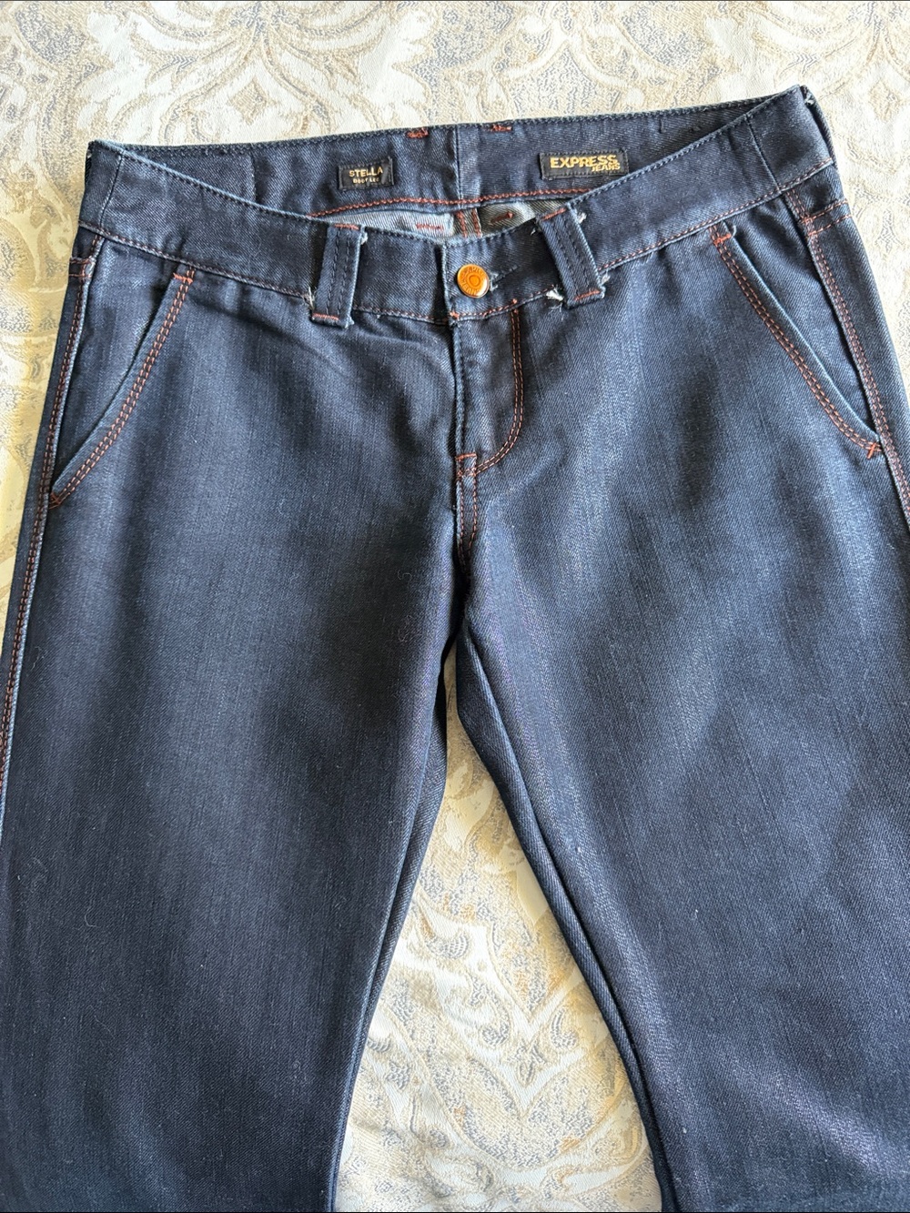 Express Dark Indigo Jeans with Brown Contrast Stitching. Shimmer finish